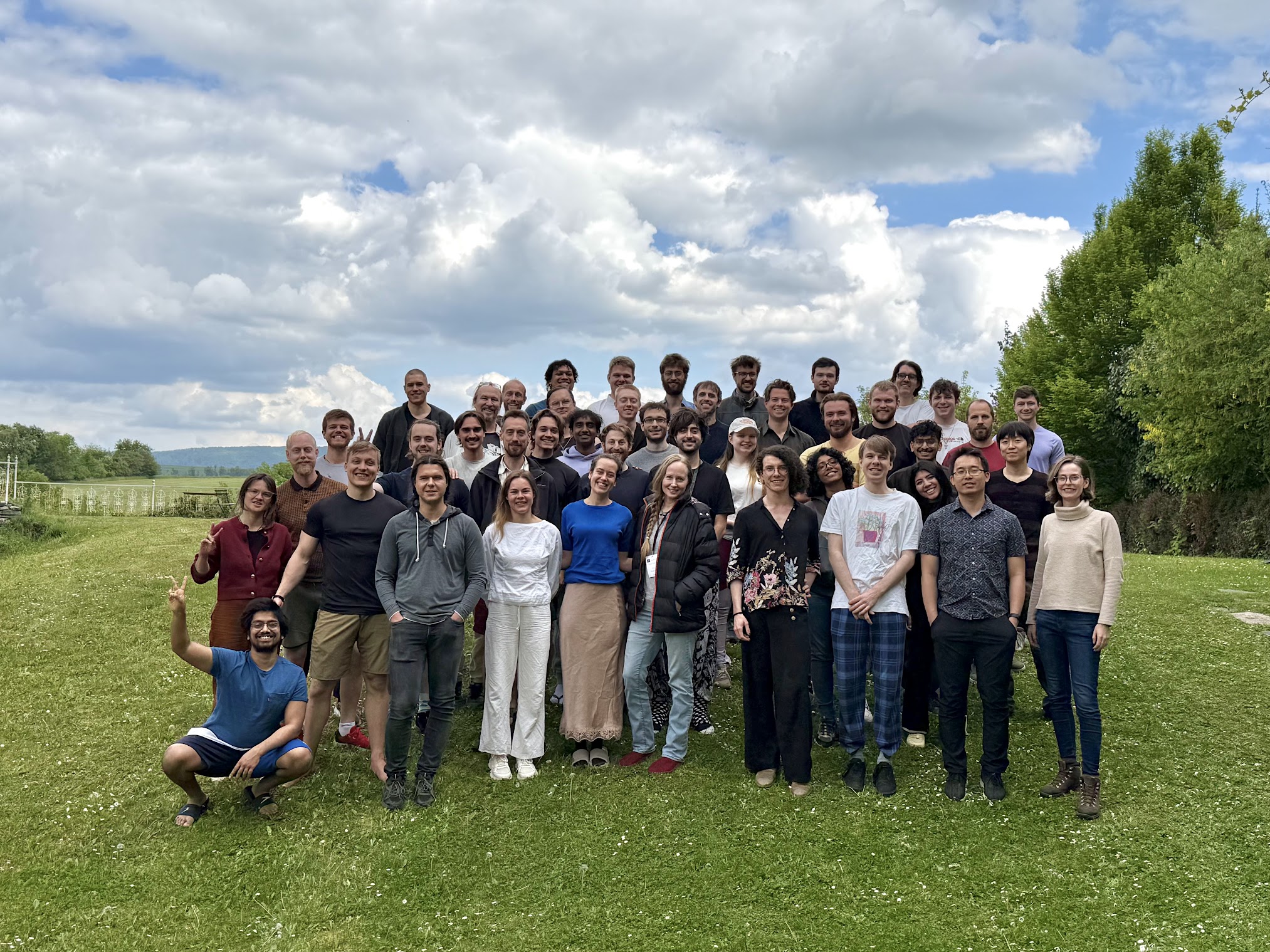 Group photo of the AFFINE seminar cohort on the lawn at Hostačov Château